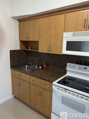 Miami apartment for rent - A room with white walls and a wooden floor.