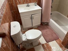Miami apartment for rent - A bathroom with a toilet, sink, and shower.