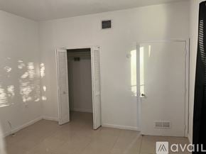 Miami apartment for rent - A bedroom with a bed and a ceiling fan.