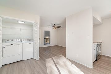 Charlotte house for rent - A white kitchen with a washer and dryer in it.