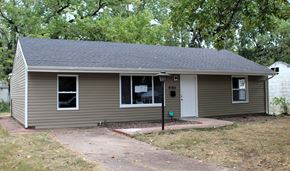 St. Louis house for rent - A small house with a brown roof and grey siding.