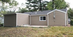 St. Louis house for rent - A small house with a grey roof and a brown siding.