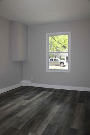 St. Louis house for rent - A room with a window and wooden flooring.