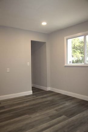 St. Louis house for rent - A room with a grey door and a window with a view of trees outside.