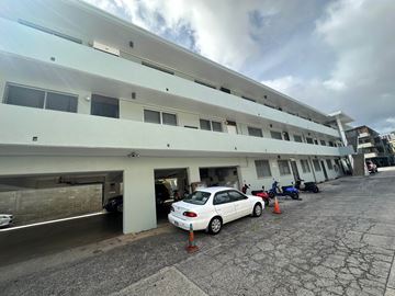 Honolulu apartment for rent - A car is parked in a parking garage.