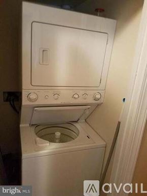 District Heights apartment for rent - A white washing machine with a door open and water in the bottom.