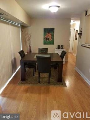 District Heights apartment for rent - A dining room with a wooden table and chairs.
