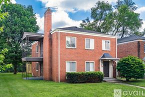 Columbus townhouse for rent - A red brick house with a black roof and a chimney.