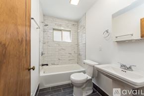 Columbus townhouse for rent - A bathroom with a toilet, sink, and bathtub.