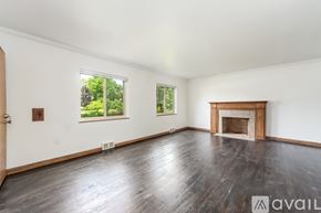 Columbus townhouse for rent - A spacious room with a fireplace and wood flooring.