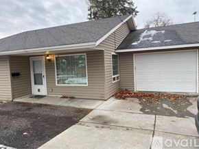 College Place apartment for rent - A house with a white door and a garage door is available for rent.