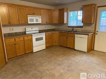 College Place apartment for rent - A kitchen with wooden cabinets and a white oven.