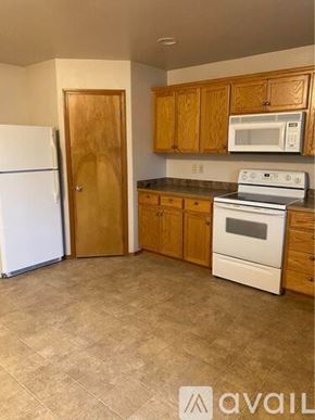 College Place apartment for rent - A kitchen with a white fridge, white microwave, and white oven.
