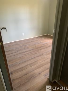Zebulon apartment for rent - A room with wooden flooring and a door with a keyhole.