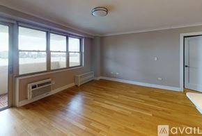 New York apartment for rent - A room with wooden floors and a window seat.