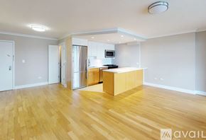 New York apartment for rent - A kitchen area with wooden flooring and a refrigerator.