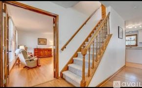 Stafford house for rent - A living room with a staircase leading to the upper floor.