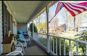 Stafford house for rent - A porch with a flag and a birdhouse.