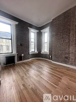 New York apartment for rent - A room with wooden floors and brick walls.