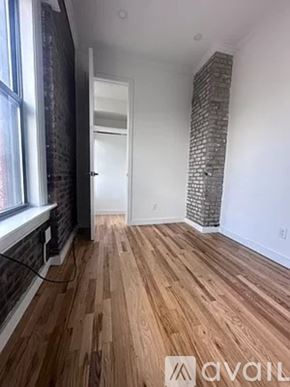 New York apartment for rent - A room with wooden flooring and a brick pillar.