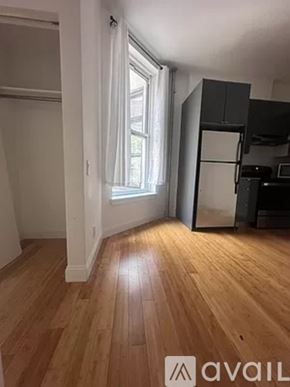 New York apartment for rent - A room with wooden floors and a window.
