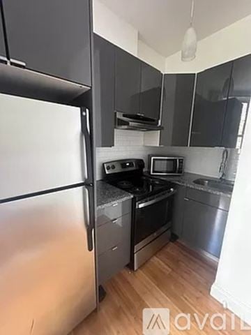 New York apartment for rent - A kitchen with a refrigerator, stove, and microwave.