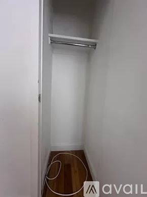 New York apartment for rent - A small, empty room with a wooden floor and a white wall.