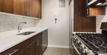 New York apartment for rent - A kitchen with a stove, sink, and cabinets.