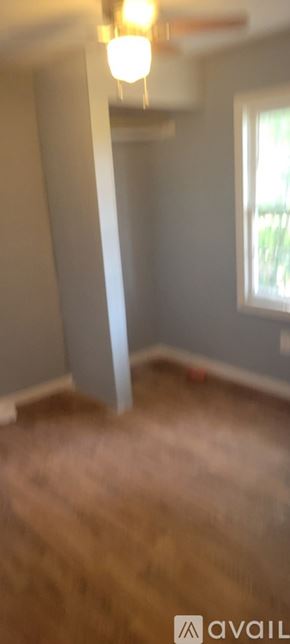 Dublin apartment for rent - A room with a wooden floor and a window.