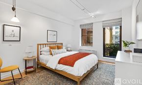 New York apartment for rent - A bedroom with a large bed and a chair.
