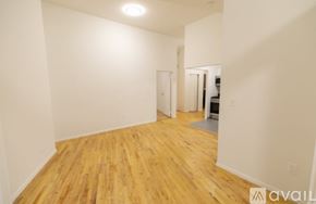 New York apartment for rent - A room with wooden floors and white walls.