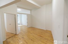 New York apartment for rent - A room with wooden floors and white walls.