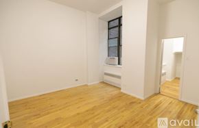 New York apartment for rent - A room with wooden floors and a window.