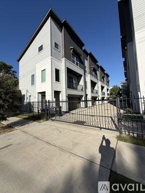 Houston house for rent - A modern two-story building with a black gate in front.