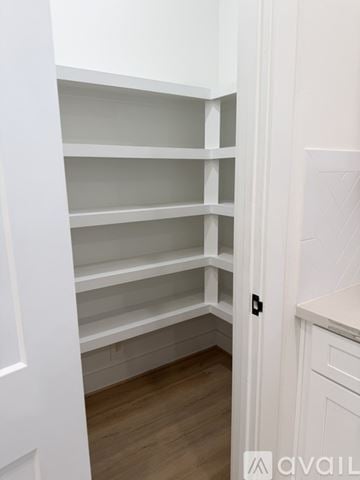 Houston house for rent - Empty white shelves in a kitchen.
