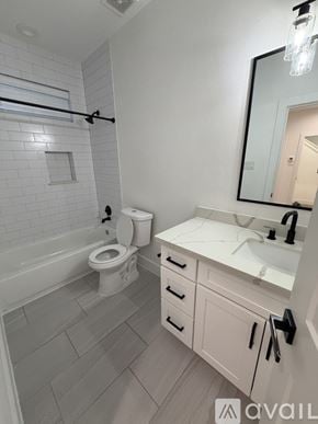 Houston house for rent - A bathroom with a toilet, sink, and bathtub.