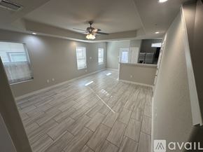San Antonio townhouse for rent - A spacious room with a ceiling fan and lighting fixture.