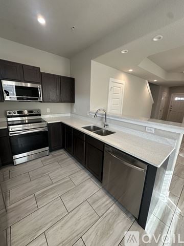 San Antonio townhouse for rent - A modern kitchen with a stove top oven and a sink.