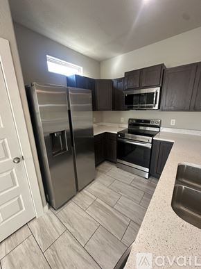 San Antonio townhouse for rent - A kitchen with a stainless steel refrigerator and oven.