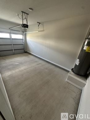 San Antonio townhouse for rent - A room with a wooden floor and a white wall with a garage door opener on the wall.