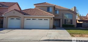 Palmdale house for rent - A house with a garage and a tree in front of it.