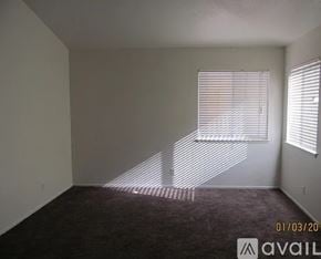 Palmdale house for rent - A bathroom with orange walls and a white toilet.