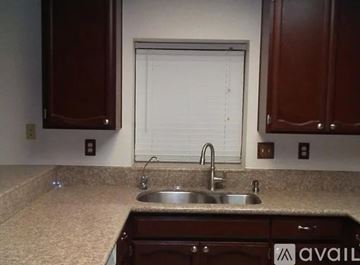 Palmdale house for rent - A small, clean kitchen with a dishwasher and a washing machine.