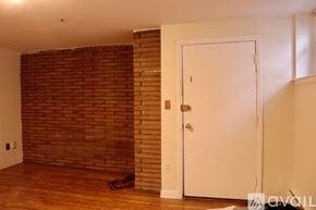 Boston apartment for rent - A room with a white door and a brick wall.