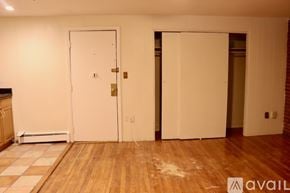 Boston apartment for rent - A room with two white doors and wooden floors.