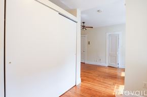 Boston apartment for rent - A room with a wooden floor and a ceiling fan.