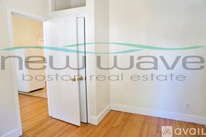 Boston apartment for rent - A room with a white door and a sign that says "new wave boston real estate available".
