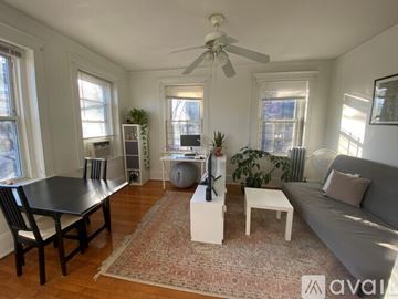 Boston apartment for rent - A living room with a black table and a grey couch.