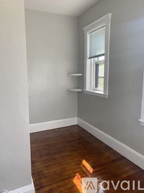 Boston apartment for rent - A room with a window and a wooden floor.