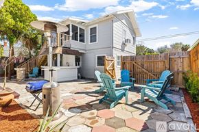 St. Petersburg apartment for rent - A patio with chairs and a table is in front of a house.